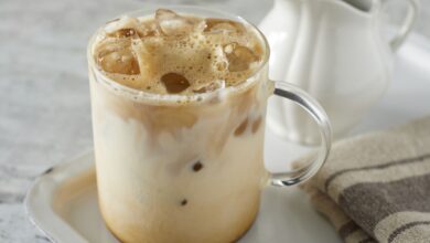 A glass of refreshing homemade iced coffee with milk and ice cubes