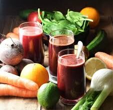 Fresh fruit and vegetable juices with carrots, beets, and green apples