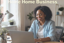 person working happily from a home office setup, with a laptop, notebook, and phone, symbolizing a successful home-based business.