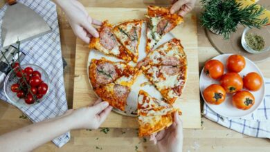 A side-by-side view of traditional pepperoni pizza and gourmet pizza with exotic toppings like duck and arugula